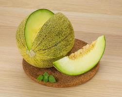 Melon on wooden board and wooden background photo