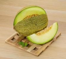 Melon on wooden board and wooden background photo