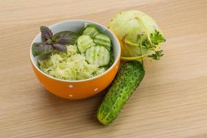 Kohlrabi salad in a bowl on wooden background photo