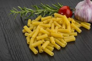 Penne on wooden background photo