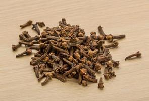 Clove seeds on wooden background photo