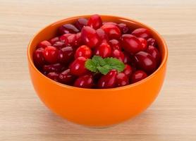 Cornus in a bowl on wooden background photo