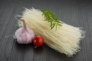 Rice noodles on wooden background photo