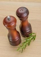 Pepper mill on wooden background photo