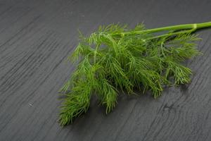 Dill on wooden background photo