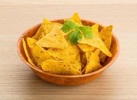 Nachos in a bowl on wooden background photo