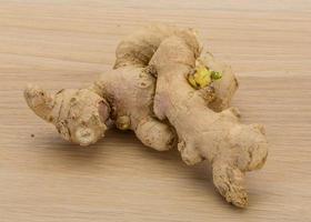 Ginger on wooden background photo