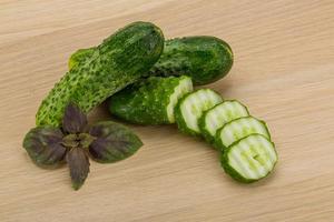 Cucumber on wooden background photo