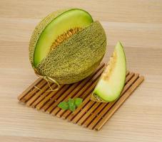 Melon on wooden board and wooden background photo