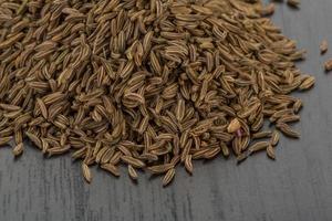 Caraway on wooden background photo