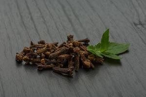 Clove seeds on wooden background photo