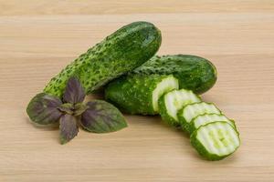 Cucumber on wooden background photo