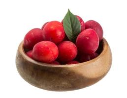 Damson plum in a bowl on white background photo