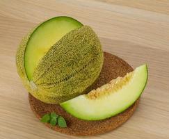 Melon on wooden board and wooden background photo