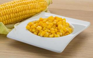 Sweet corn in a bowl on wooden background photo