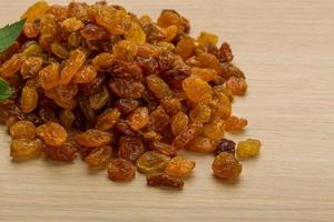 Raisin on wooden background photo