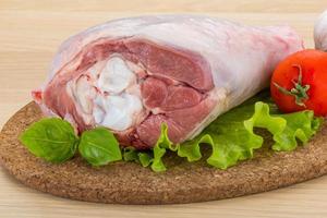 Turkey leg on wooden board and wooden background photo