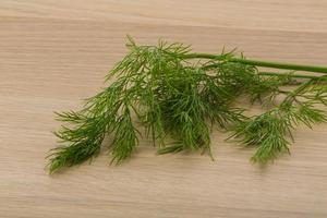 Dill on wooden background photo