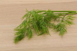 Dill on wooden background photo