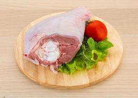 Turkey leg on wooden board and wooden background photo