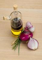 Oil, vinegar with onion on wooden background photo
