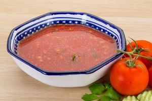 Gaspacho in a bowl on wooden background photo