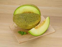 Melon on wooden board and wooden background photo