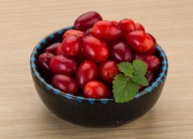 Cornus in a bowl on wooden background photo