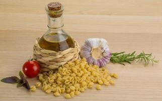 Shell pasta on wooden background photo