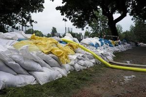 Extreme weather - a line of sand bags and hoses to pump water out of flooded basements in Dusseldorf, Germany photo