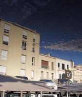 Buildings reflected in water in Marseille, France photo