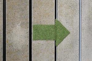 Green arrow made out of a patch of grass pointing to the right photo