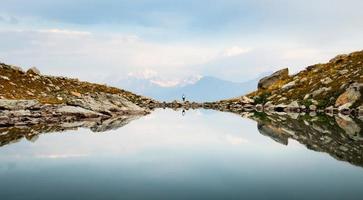 Back view person female stand on edge in nature calm landscape look to sides search purpose in life alone in scenic mountains in fall photo