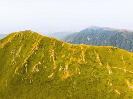 Panning aerial view group of four hikers hike on Lagodekhi national park black rock trail back photo