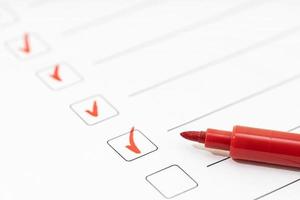 Checklist sheet and red marker. Check list completed task concept photo