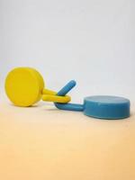 Two round blue and yellow clothes hook hangers that go hand in hand. photo