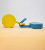 Two round blue and yellow clothes hook hangers that go hand in hand. photo