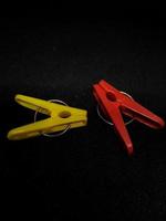 Isolated photo of clothespins in red and yellow with very contrasting colors.