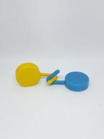 Two round blue and yellow clothes hook hangers that go hand in hand. photo