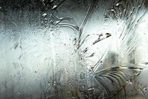 Frozen winter window with shiny ice frost pattern texture. Christmas wonder symbol, abstract background. Extreme north low temperature, natural Ice snow on frosty glass, cool winter weather outdoor. photo