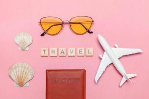 Minimal simple flat lay travel adventure trip concept on pink pastel trendy modern background photo