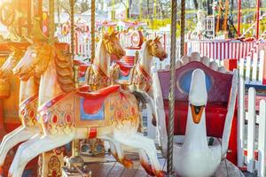 Vintage Merry-Go-Round flying horse carousel in amusement holliday park photo