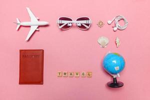 Minimal simple flat lay travel adventure trip concept on pink pastel trendy modern background photo