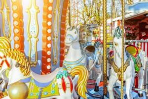 Vintage Merry-Go-Round flying horse carousel in amusement holliday park photo