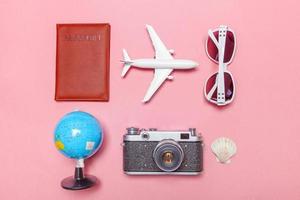 Minimal simple flat lay travel adventure trip concept on pink pastel trendy modern background photo