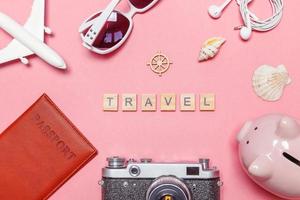 Minimal simple flat lay travel adventure trip concept on pink pastel trendy modern background photo