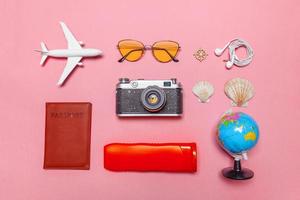 Minimal simple flat lay travel adventure trip concept on pink pastel trendy modern background photo