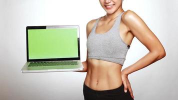 Attractive woman standing and holding laptop. photo