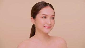 Beautiful face of Asian young woman with natural skin. Portrait of attractive girl with soft makeup and perfectly beautiful skin. photo