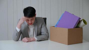 Young businessman is stressed because of being fired from his job. photo